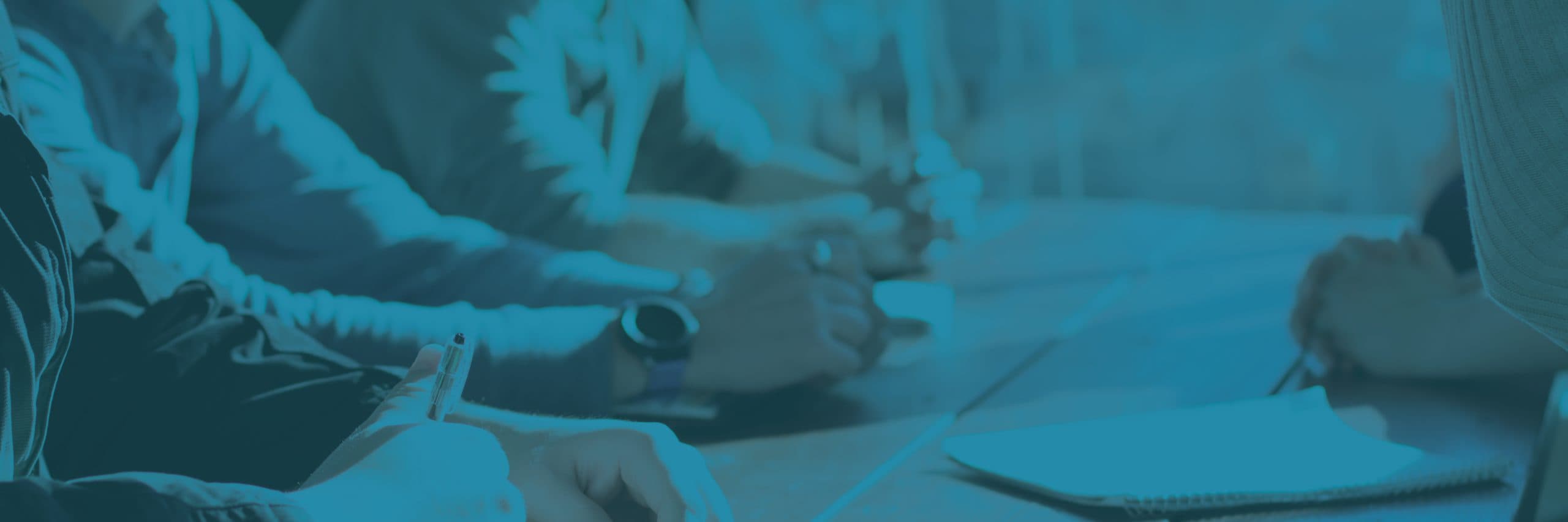Business professionals reviewing paperwork during an ExitBig consultation